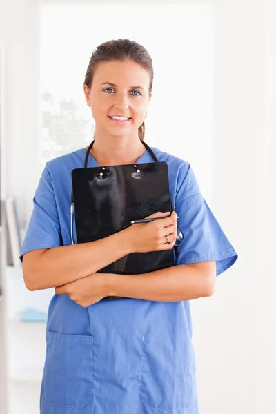 Cute nurse holding a folder — Stock Photo, Image
