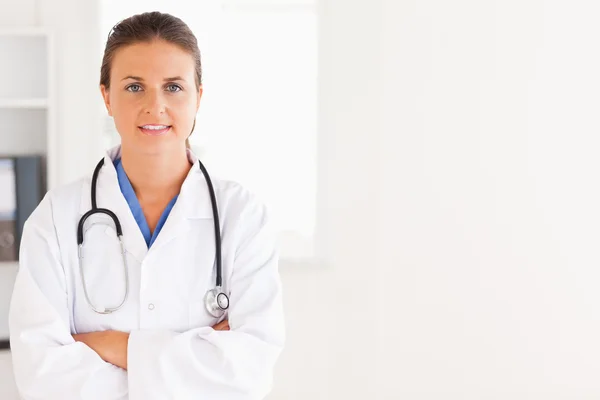 Charming doctor having a stethoscope around her neck looking int — Stock Photo, Image