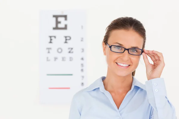 Good looking eye specialist wearing glasses looking into the cam — Stock Photo, Image