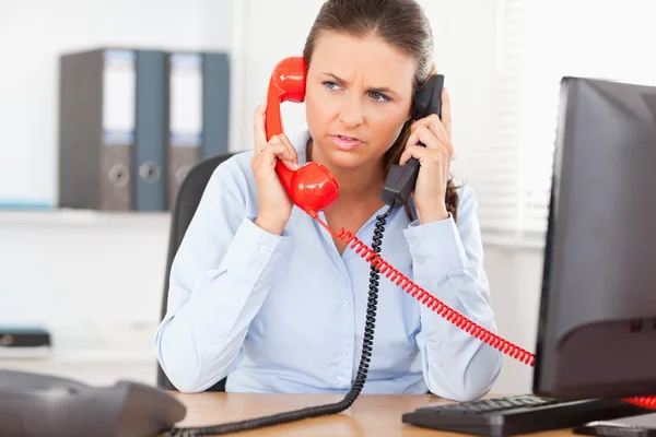 Businesswoman telephoning with two devices — Stock Photo, Image