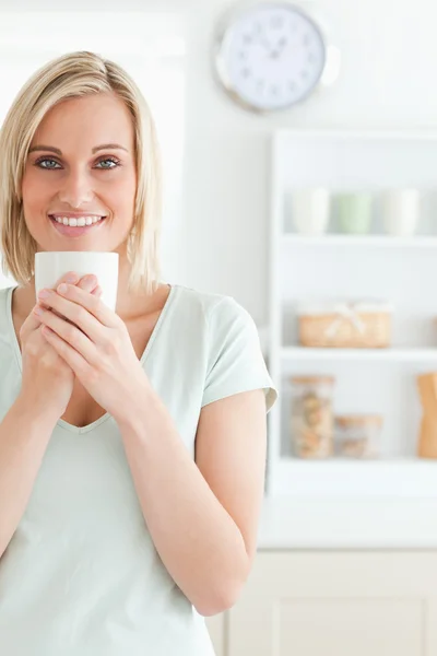 Portrait of a woman taking in smell of coffee looking into the c — Stock Photo, Image