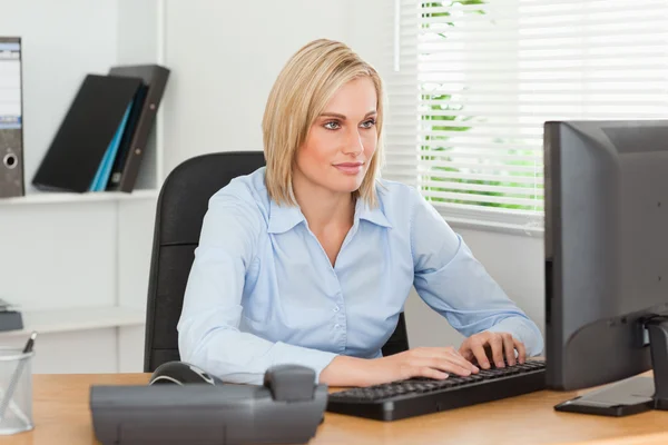 Arbetande kvinna framför en skärm — Stockfoto