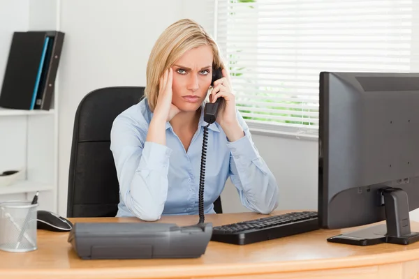 Charming businesswoman on phone while having headache looks into — Stock Photo, Image