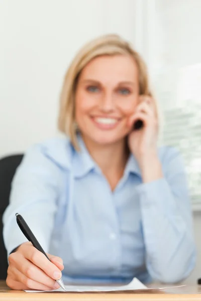 Portrait of a cute businesswoman on mobile noting something look — Stock Photo, Image