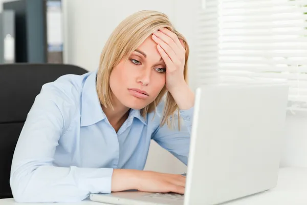 Blonde business woman touching her forehead being tired — Stock Photo, Image