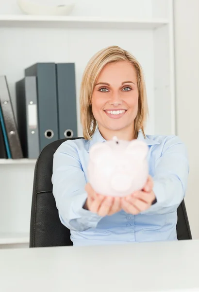 Cute smiling businesswoman holding a piggy bank — Stock Photo, Image