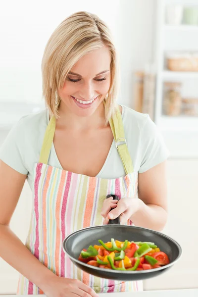 Жінка дивиться на заповнену сковороду — стокове фото