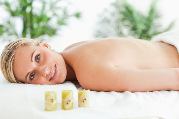 Blonde woman lying on massage lounger — Stock Photo, Image