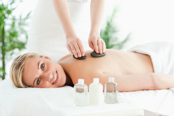 Close up of a blonde woman experiencing a stone therapy — Stock Photo, Image