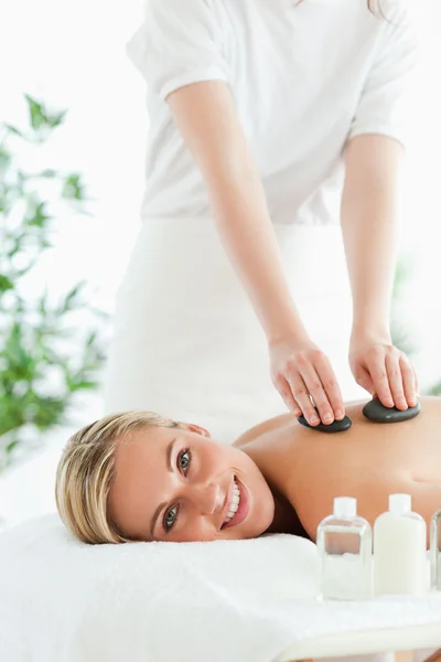 Blonde woman experiencing a stone therapy — Stock Photo, Image