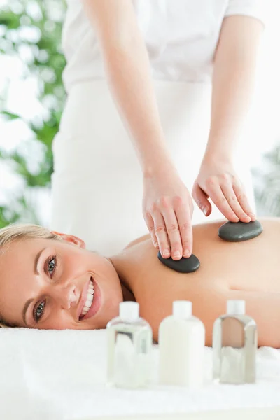 Blonde relaxed woman experiencing a stone therapy — Stock Photo, Image