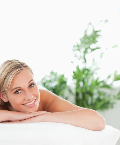 Close up of a blonde smiling woman lying on a lounger — Stock Photo, Image
