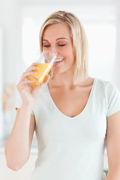 Очаровательная женщина пьет апельсиновый сок — стоковое фото