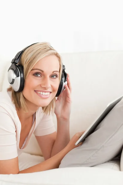 Portrait of a woman with a tablet computer and headphones — Stock Photo, Image