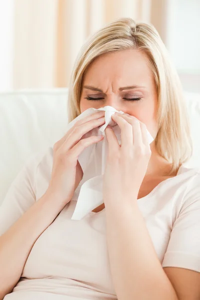 Portrait of an ill woman blowing her nose — Stock Photo, Image
