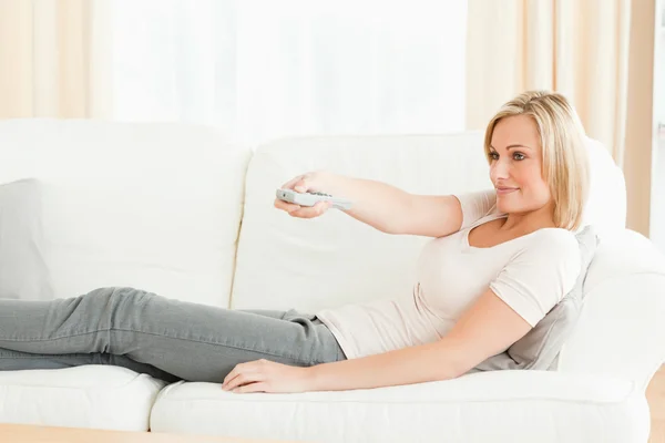 Woman using a remote — Stock Photo, Image