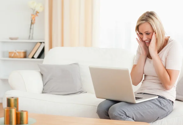 Happy woman looking at her laptop — Stock Photo, Image