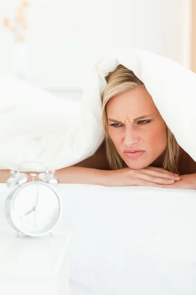 Portrait of a disgruntled woman waking up — Stock Photo, Image
