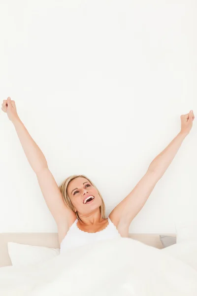 Portrait of a young woman stretching her arms — Stock Photo, Image