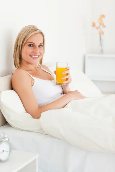 Porträtt av en kvinna som dricker apelsinjuice — Stockfoto