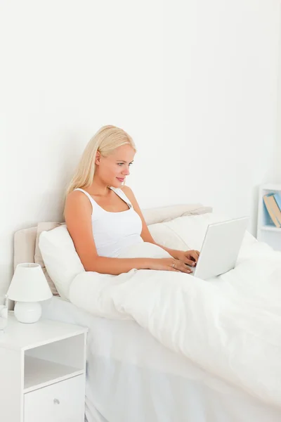 Blond kvinna använder en bärbar dator — Stockfoto