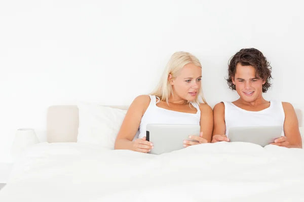 Beautiful couple using tablet computers — Stock Photo, Image