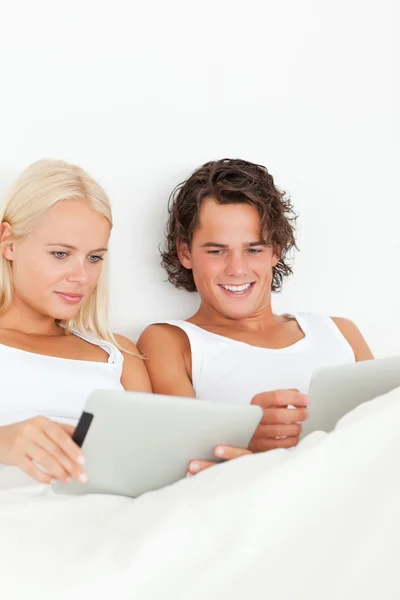 Retrato de um casal lindo usando computadores tablet — Fotografia de Stock