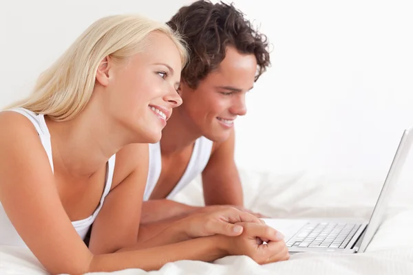 Lovely couple using a laptop — Stock Photo, Image