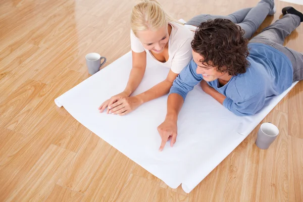 Man showing a point on a plan to his girlfriend — Stock Photo, Image
