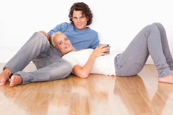 Young couple sitting together — Stock Photo, Image