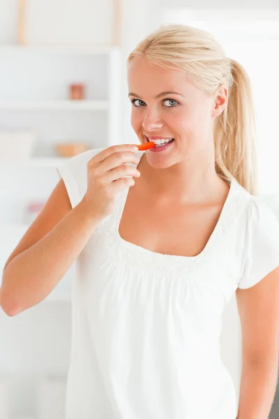 Porträt einer Frau, die eine Scheibe Paprika isst — Stockfoto