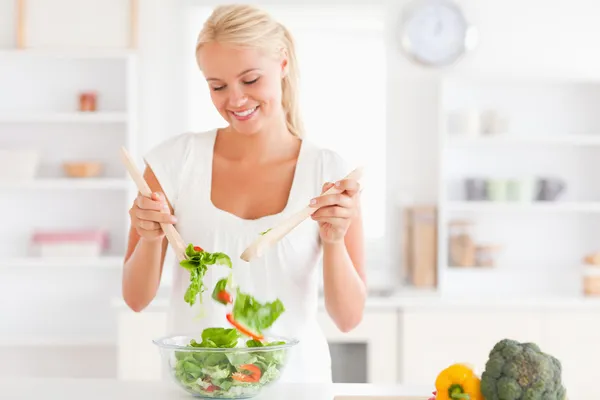 Gorgeous woman mixing a salad — Stock Photo, Image
