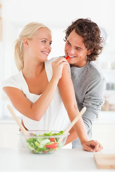 Portrait of a woman giving pepper to her fiance — Stock Photo, Image