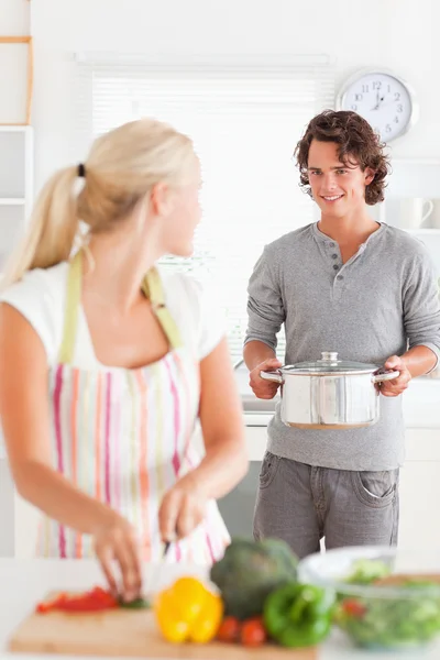 Portrait of a cute man bringing a boiler to her girlfriend — Stock Photo, Image