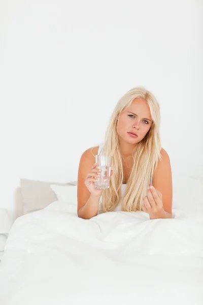Portrait of a sick woman taking her medication — Stock Photo, Image