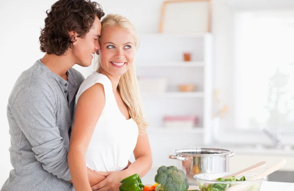 Couple hugging while cooking — Stock Photo, Image