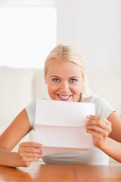 Femme souriante tenant une lettre — Photo