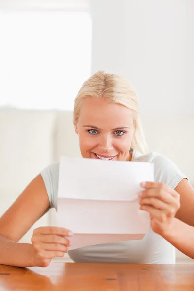 Stock image Smiling woman reading a letter