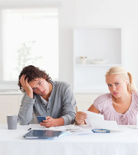 Cute despaired couple doing accounts — Stock Photo, Image