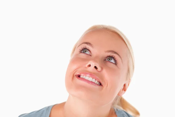 Charming blond woman looking at the ceiling — Stock Photo, Image