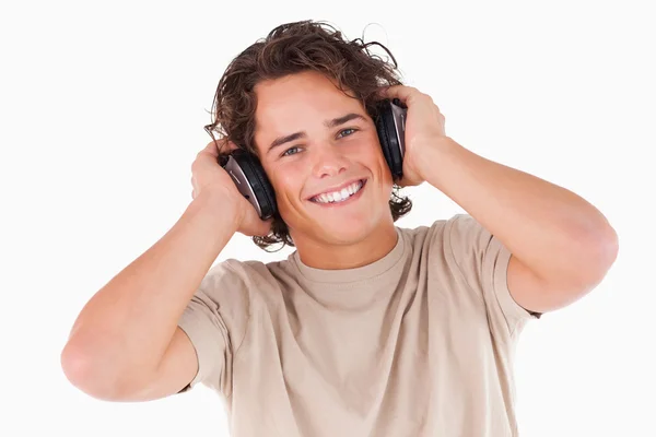 Smiling man with headphones looking into the camera — Stock Photo, Image