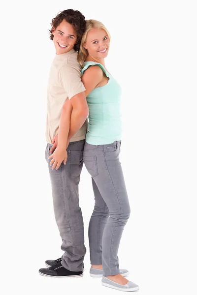 Lyckliga par stå rygg mot rygg — Stockfoto