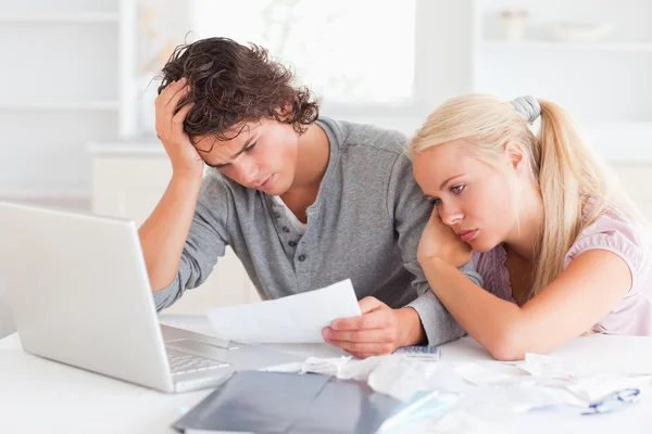 Tired couple doing their accounts — Stock Photo, Image