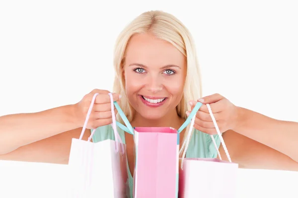 Happy woman with bags looking into the camera — Stock Photo, Image