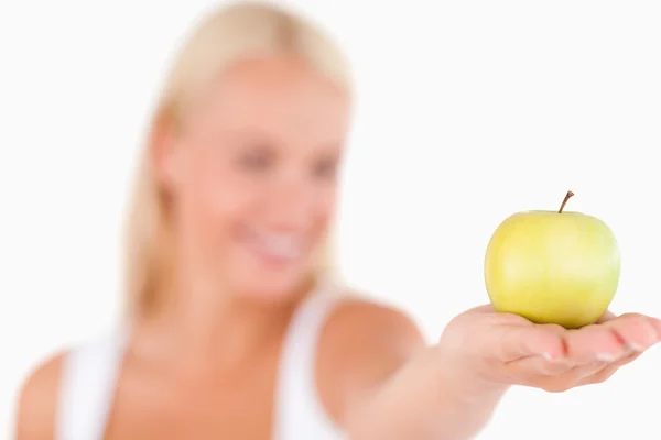 Smiling woman holding an apple — Stock Photo, Image