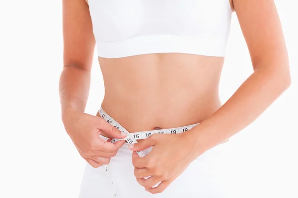 Thin woman measuring her waist — Stock Photo, Image
