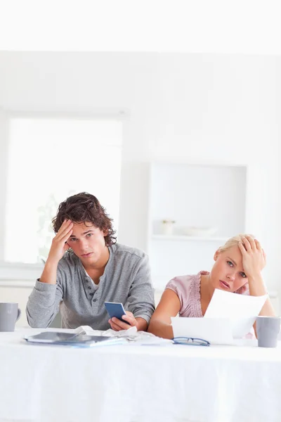 Worn out couple calculating their expenses — Stock Photo, Image