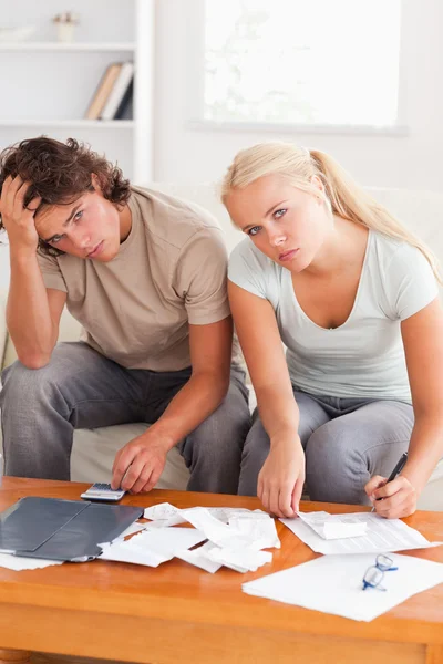 Despaired stressed couple calculating their expenses — Stock Photo, Image