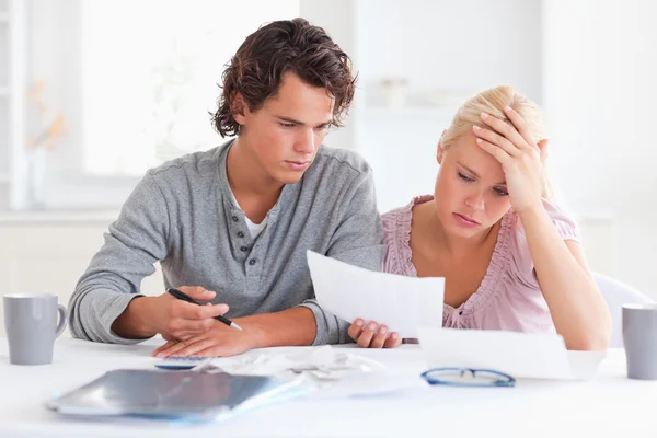 Worn out couple listing expenses — Stock Photo, Image