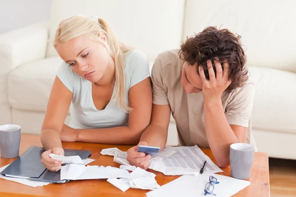 Unhappy couple listing expenses — Stock Photo, Image